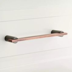 an image of a bathroom towel bar on the wall with white walls in the background