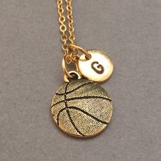 Basketball charm necklace with hand stamped initial *Can choose chain length *Initial charm is antique gold pewter 9mm *Basketball charm is antique gold pewter *Your purchase will arrive packaged in a cute gift box and I will include a message by request. Add on a birthstone charm for $3.00 https://www.etsy.com/listing/235600956 Additional Hand stamped initial charm $3.50 https://www.etsy.com/listing/232868096 *Go back to Toodaughters https://www.etsy.com/shop/Toodaughters Basketball Necklace, Sports Jewelry, Leather Bangle, Necklace Initial, Cute Gift Boxes, Presents For Friends, Initial Bracelet, Personalized Bracelets, Charm Bangle