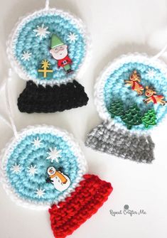 three crocheted christmas ornaments with santa hats on them and snowflakes hanging from strings