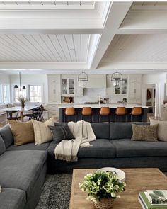 a living room filled with lots of furniture and decor on top of a hard wood floor