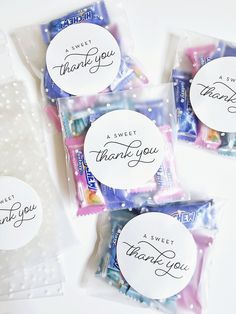 four candy bags with thank you stickers on them