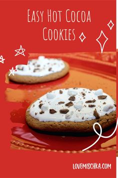 two cookies with marshmallows and chocolate chips on them are sitting on a red plate