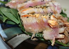 two pieces of meat sitting on top of green leaves