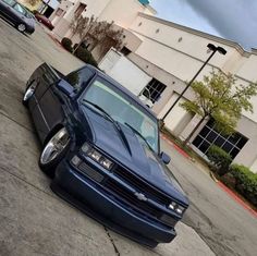 a blue car parked in front of a building