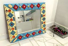 a mirror sitting on top of a tiled floor next to a basket filled with shoes