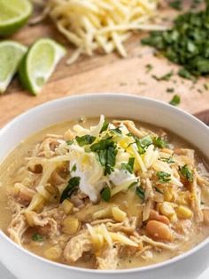 a white bowl filled with chicken tortilla soup and garnished with cilantro