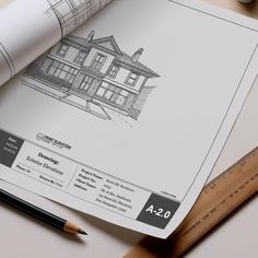 a drawing of a house on top of a piece of paper next to a ruler