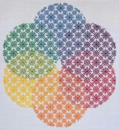 the cross stitch pattern has four circles in different colors