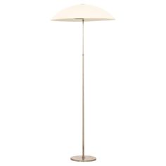 a floor lamp with a white shade on the top and an oval light fixture at the bottom