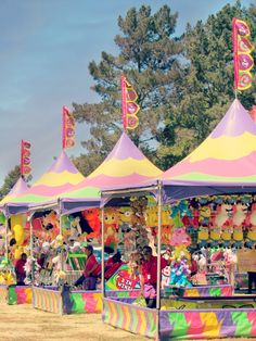 several carnival booths with stuffed animals on them