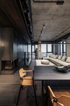 a living room with a couch, table and chairs next to an open fire place