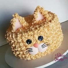 a cake shaped like a cat with ears and eyes