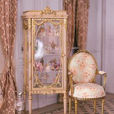 a chair sitting next to a china cabinet in a room with gold trimmings