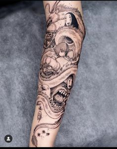 a woman's arm with tattoos on it and an image of a demon in the background