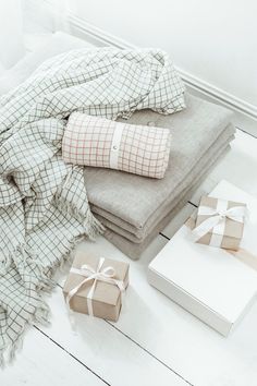 a blanket, wrapped gift boxes and other items on the floor