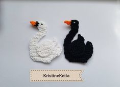 two crocheted ducks sitting next to each other