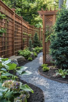 A serene garden walkway with wooden lattice fencing, lush plants, small trees, and a gravel path winding through under dappled sunlight. Outdoor Privacy Trellis, Living Fence Ideas Yard Privacy, Outside Privacy Wall Ideas, Small Narrow Backyard, Create Backyard Privacy, Fence Privacy Ideas, Side Yards Ideas Narrow, Outdoor Curtain Ideas, Pink Winter Wonderland Baby Shower