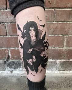 a person with a black and white tattoo on their leg