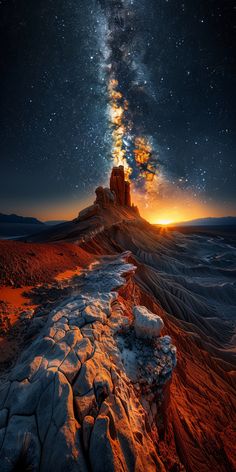 the milky shines brightly in the night sky above a desert landscape with rocks and snow