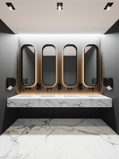 a bathroom with marble counter tops and mirrors on the wall, along with three sinks