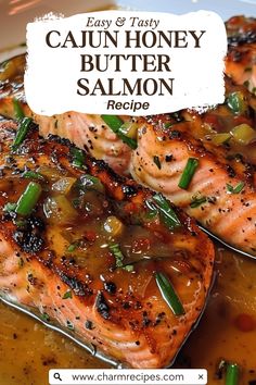 two salmon fillets with onions and green peppers in a sauce on a white plate