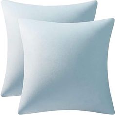 two white pillows sitting next to each other