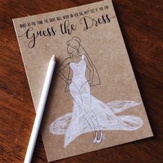 a notepad with a drawing of a woman in a dress on it and a pen next to it