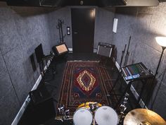 a drum set up in the corner of a room