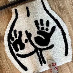 a white rug with black hand prints on it