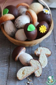 a basket filled with lots of different types of pastries on top of a wooden table