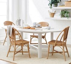 a white table with two chairs around it