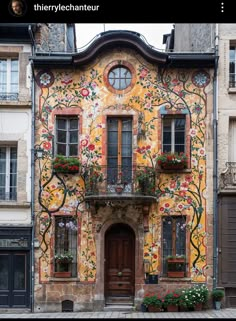 an old building with flowers painted on it