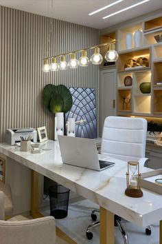 a white desk topped with a laptop computer