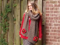 a woman standing in front of a wooden fence wearing a scarf with flowers on it