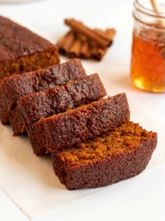 slices of cake sitting on top of a white plate next to a cup of tea