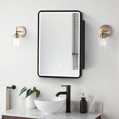 a bathroom sink with a mirror above it and a bowl on the counter next to it