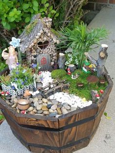 a wooden barrel filled with lots of rocks and plants