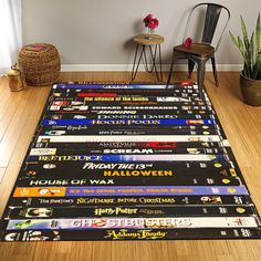 a large area rug with many different movie titles on the floor next to a chair