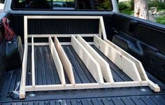 the back end of a pickup truck with wooden bed rails