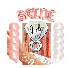 the bride balloons are pink and have white letters on them, along with other decorations