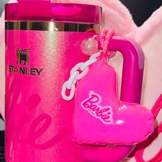 a pink cup with a heart shaped keychain attached to it