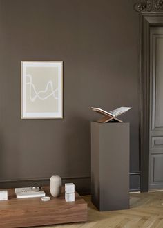 a living room with a tv, books and other items on the table in front of it