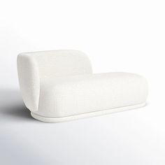 a white couch sitting on top of a white floor