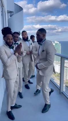 a group of men in white suits standing next to each other