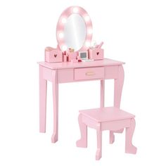 a pink vanity table with a mirror and stool