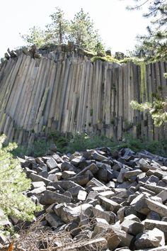 a large pile of rocks next to a wooden fence