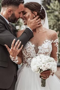 the bride and groom are hugging each other