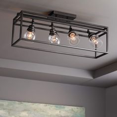 a light fixture with three bulbs hanging from the ceiling