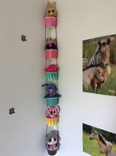 there is a wall shelf with many hats on it and animals hanging from the top