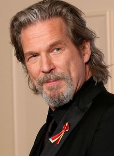 a man with grey hair wearing a suit and tie